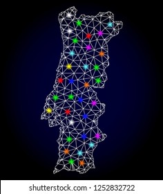 Glossy polygonal mesh map of Portugal with glare effect. Vector carcass map of Portugal with glowing multi colored spheres for Christmas templates. White mesh lines. Dark blue background.