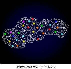 Glossy polygonal mesh map of Slovakia with glow effect. Vector carcass map of Slovakia with glowing multicolored dots for Christmas posters. White mesh lines. Dark blue background.