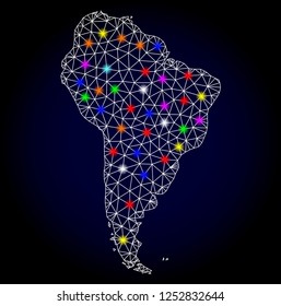 Glossy polygonal mesh map of South America with glare effect. Vector carcass map of South America with glowing multi colored spheres for New Year posters. White mesh lines. Dark blue background.