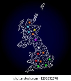 Glossy polygonal mesh map of United Kingdom with glow effect. Vector carcass map of United Kingdom with glowing multi colored dots for Christmas posters. White mesh lines. Dark blue background.
