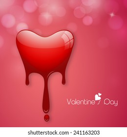 Glossy red heart shape on shiny pink background for Happy Valentine's Day celebrations.