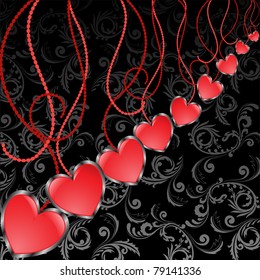 glossy red hearts hanging diagonal on a black background