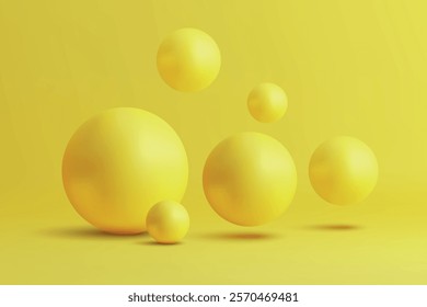 Glossy yellow spheres resting and floating on a vibrant yellow surface, creating a dynamic composition.