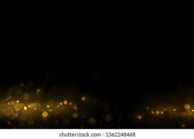 Glowing bokeh lights, shiny particles explode on black background