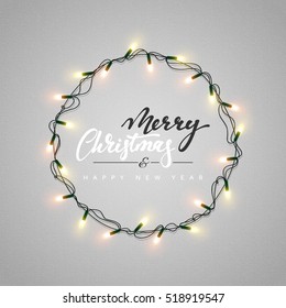 Glowing Christmas Lights Wreath For Xmas Holiday Greeting Cards Design. Merry Christmas Lettering Label. Glowing Lights Garlands Xmas Holiday Greeting Card Design