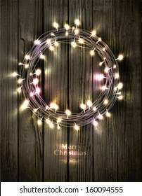 Glowing Christmas Wreath Made Of Led Lights On The Wooden Background