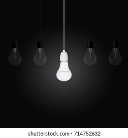 Glowing energy saving lamp among several turned off lamps on a dark background. Vector illustration for your design