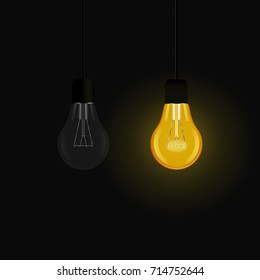 A glowing incandescent lamp and a light bulb turned off  on a dark background
