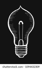 Glowing light incandescent bulb. Vector vintage white engraving illustration on black background