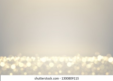 Glowing lights effect. Defocused golden glitter dust. Abstract sparkling magical background