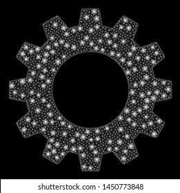 Glowing mesh gear with glare effect. Abstract illuminated model of gear icon. Shiny wire frame polygonal mesh gear. Vector abstraction on a black background.