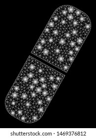 Glowing mesh pill with sparkle effect. Abstract illuminated model of pill icon. Shiny wire frame triangular mesh pill. Vector abstraction on a black background.