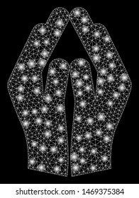 Glowing mesh pray hands with sparkle effect. Abstract illuminated model of pray hands icon. Shiny wire carcass polygonal network pray hands. Vector abstraction on a black background.