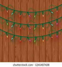 Glowing multicolored Christmas Lights Three lines on wooden background. Template for Xmas Holiday Greeting Cards Design. Vector illustration