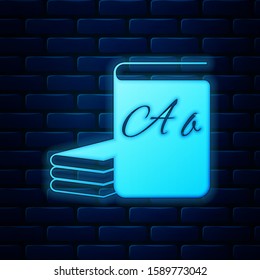 Glowing neon ABC book icon isolated on brick wall background. Dictionary book sign. Alphabet book icon. Vector Illustration