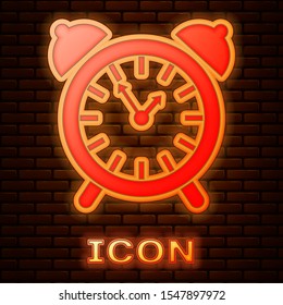 Glowing neon Alarm clock icon isolated on brick wall background. Wake up, get up concept. Time sign.  Vector Illustration
