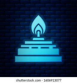 Glowing neon Alcohol or spirit burner icon isolated on brick wall background. Chemical equipment.  Vector Illustration