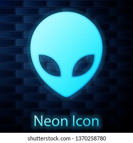 Glowing neon Alien icon isolated on brick wall background. Extraterrestrial alien face or head symbol. Vector Illustration