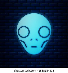 Glowing neon Alien icon isolated on brick wall background. Extraterrestrial alien face or head symbol.  Vector Illustration