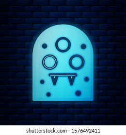 Glowing neon Alien icon isolated on brick wall background. Extraterrestrial alien face or head symbol.  Vector Illustration