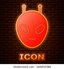 Glowing neon Alien icon isolated on brick wall background. Extraterrestrial alien face or head symbol.  Vector Illustration