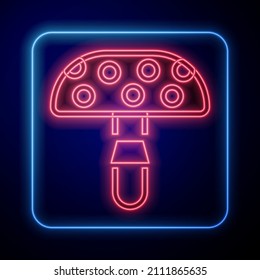 Glowing neon Amanita muscaria or fly agaric hallucinogenic toadstool mushroom icon isolated on black background. Spotted poisonous mushroom.  Vector