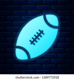 Glowing neon American Football ball icon isolated on brick wall background.  Vector Illustration