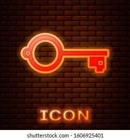 Glowing neon Ancient key for game icon isolated on brick wall background.  Vector Illustration