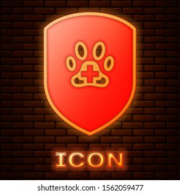 Glowing neon Animal health insurance icon isolated on brick wall background. Pet protection icon. Dog or cat paw print.  Vector Illustration