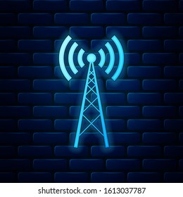 Glowing neon Antenna icon isolated on brick wall background. Radio antenna wireless. Technology and network signal radio antenna.  Vector Illustration