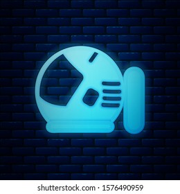 Glowing neon Astronaut helmet icon isolated on brick wall background.  Vector Illustration