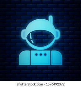Glowing neon Astronaut icon isolated on brick wall background.  Vector Illustration