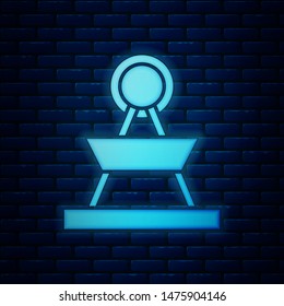 Glowing neon Attraction carousel icon isolated on brick wall background. Amusement park. Childrens entertainment playground, recreation park.  Vector Illustration