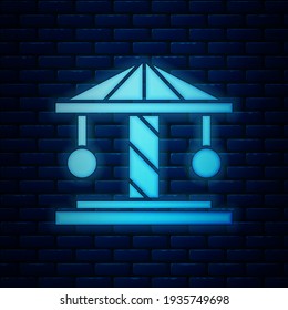 Glowing neon Attraction carousel icon isolated on brick wall background. Amusement park. Childrens entertainment playground, recreation park.  Vector