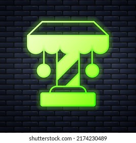 Glowing neon Attraction carousel icon isolated on brick wall background. Amusement park. Childrens entertainment playground, recreation park.  Vector