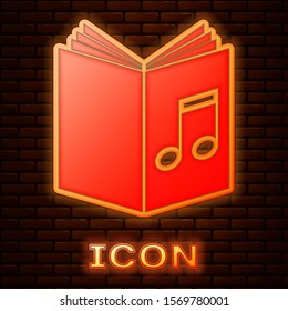 Glowing neon Audio book icon isolated on brick wall background. Musical note with book. Audio guide sign. Online learning concept.  Vector Illustration