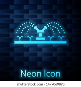 Glowing neon Automatic irrigation sprinklers icon isolated on brick wall background. Watering equipment. Garden element. Spray gun icon.  Vector Illustration