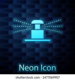 Glowing neon Automatic irrigation sprinklers icon isolated on brick wall background. Watering equipment. Garden element. Spray gun icon.  Vector Illustration