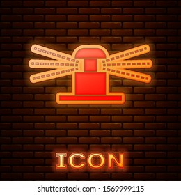 Glowing neon Automatic irrigation sprinklers icon isolated on brick wall background. Watering equipment. Garden element. Spray gun icon.  Vector Illustration