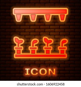 Glowing neon Automatic irrigation sprinklers icon isolated on brick wall background. Watering equipment. Garden element. Spray gun icon.  Vector Illustration