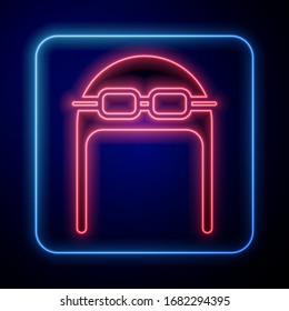 Glowing neon Aviator hat with goggles icon isolated on blue background. Pilot hat.  Vector Illustration
