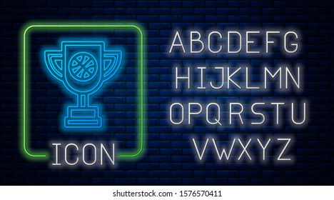 Glowing neon Award cup with basketball ball icon isolated on brick wall background. Winner trophy symbol. Championship or competition trophy. Neon light alphabet. Vector Illustration