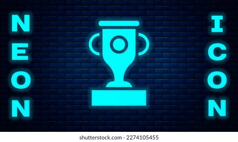 Glowing neon Award cup icon isolated on brick wall background. Winner trophy symbol. Championship or competition trophy. Sports achievement sign.  Vector