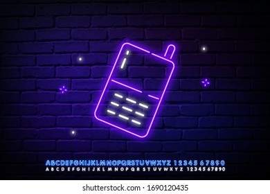 Glowing neon Baby Monitor Walkie Talkie icon isolated on brick wall background. Vector Illustration
