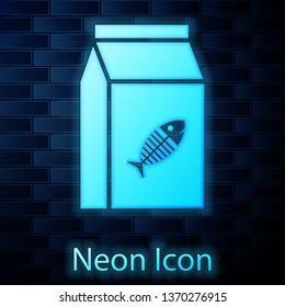 Glowing neon Bag of food for cat icon isolated on brick wall background. Fish skeleton sign. Food for animals. Pet food package. Vector Illustration