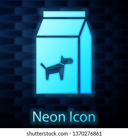 Glowing neon Bag of food for dog icon isolated on brick wall background. Food for animals. Pet food package. Vector Illustration