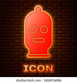 Glowing neon Balaclava icon isolated on brick wall background. A piece of clothing for winter sports or a mask for a criminal or a thief.  Vector Illustration