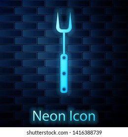 Glowing neon Barbecue fork icon isolated on brick wall background. BBQ fork sign. Barbecue and grill tool. Vector Illustration