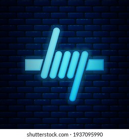 Glowing neon Barbed wire icon isolated on brick wall background.  Vector