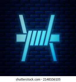 Glowing neon Barbed wire icon isolated on brick wall background.  Vector